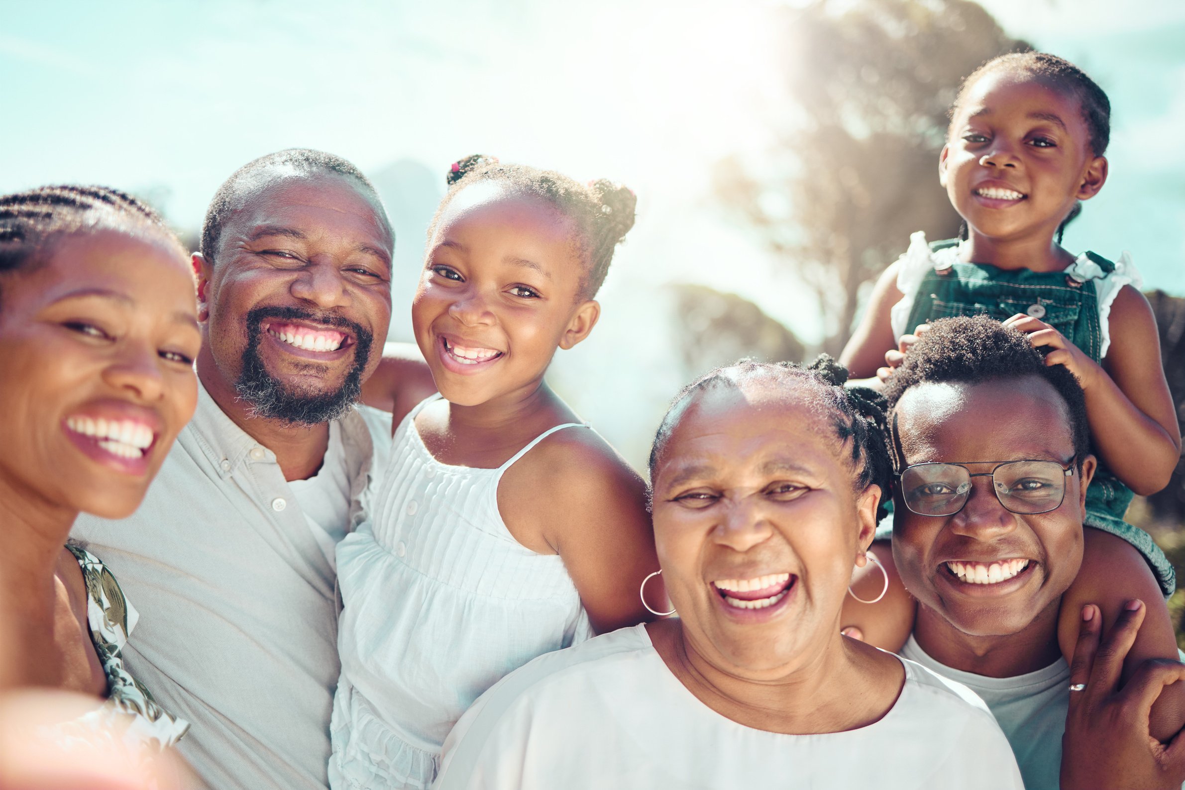 Portrait, Happy Black Big  and Love as They Smile on Vacation, Trip or Holiday. Ancestry, African People or Grandparent, Fathers and Mother with Kids Together in the Shining Sun or Sunshine.